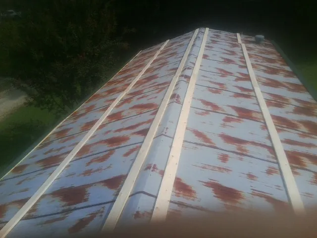 Rusted metal roof panels with new wood purlins before replacement — Storm Damage Roof Repair in Polk City by Roofing Brothers